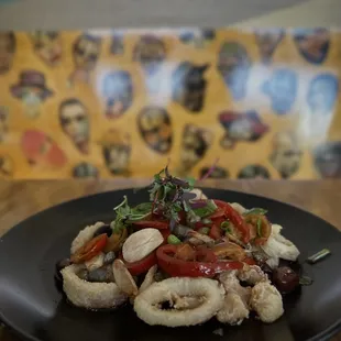 a plate of squid and vegetables