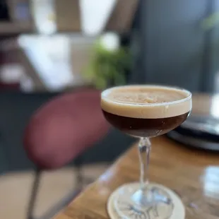 a glass of coffee on a table