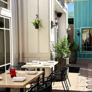 a patio with tables and chairs