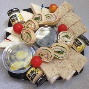 a platter of sandwiches and condiments