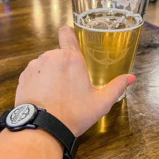 a person holding a glass of beer