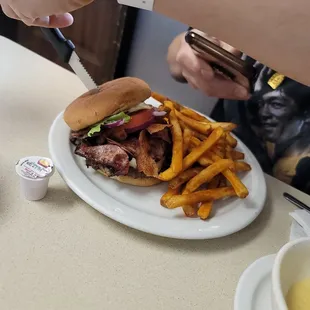 Grinder burger with French fries.
