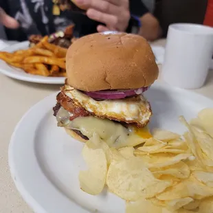 a burger and chips on a plate