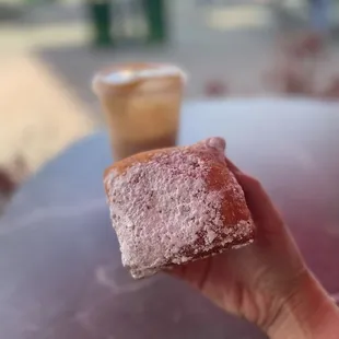 a hand holding a doughnut