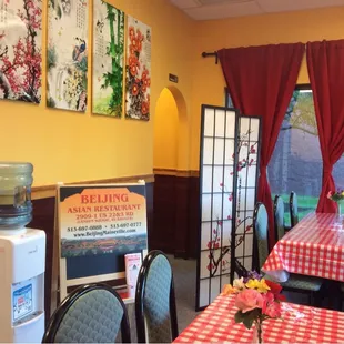 tables and chairs with red and white checkered tablecloths
