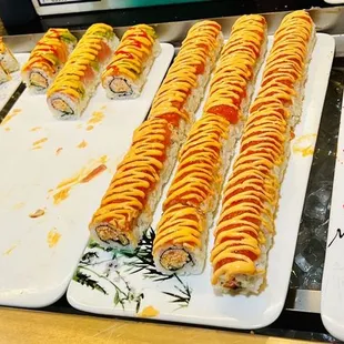 a variety of sushi rolls on plates