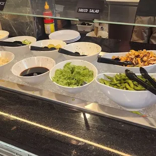 various bowls of food on a counter