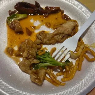 a plate of chinese food with a fork