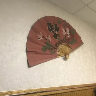 a fan hanging on the wall