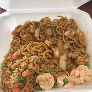 a takeout container with noodles and shrimp