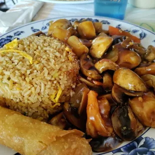 Mushrooms, shrimp, and scallops with fried rice and egg roll.
