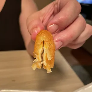 a person holding a half eaten pastry