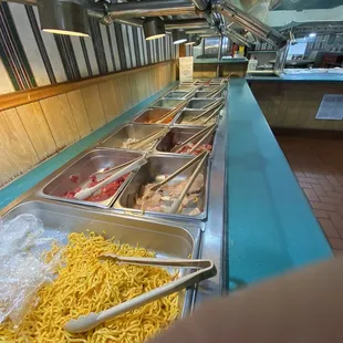 a buffet of noodles and meats