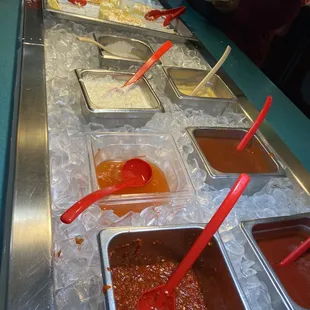 a line of hot sauces and condiments