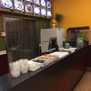 a restaurant counter with a variety of food items