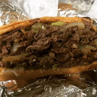 a beef sandwich wrapped in foil