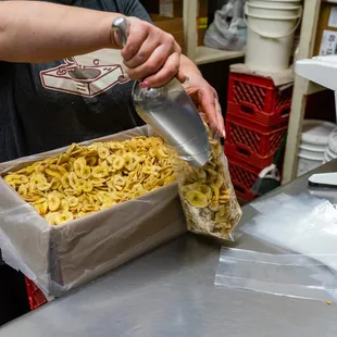 a person pouring something into a bag