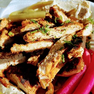 Chicken shawarma over smooth, creamy hummus