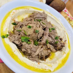 Hummus topped with meat!