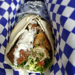 Falafel and Kibbe wrap with green salad, Taboule, hummus, and tahini sauce. So yummy and healthy