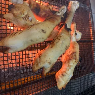 a bunch of meat being cooked on a grill
