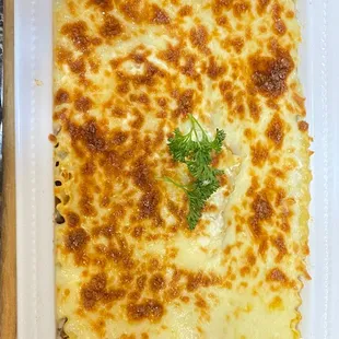 a casserole dish with cheese and herbs