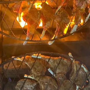 a grill full of meat being cooked