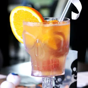 a drink in a glass with an orange slice