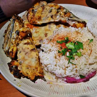 a plate of food with rice and meat