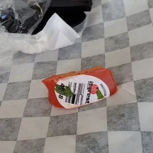 a hot dog wrapper on a checkered floor