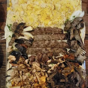 a tray of meat, rice, and vegetables