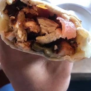 a hand holding a burrito