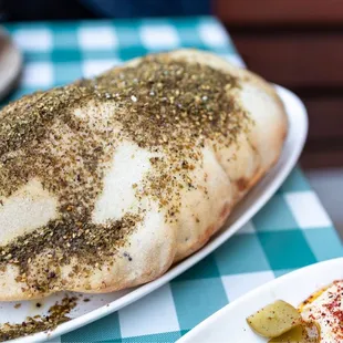 Samir's Hand Kneaded Bread - fresh pita with caraway, nigella, thyme topped with zaa'tar and sumac
