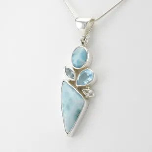 Beautiful blue Caribbean larimar set with white topaz and blue topaz accent stones. One of a kind and unique handmade jewelry.