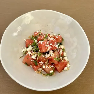 Summer Watermelon Salad - Feta, cucumber, mint, sliced red onion, Marcona almonds, lemon, mint vinaigrette.