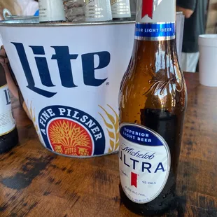 two bottles of lite beer on a table