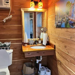 a bathroom with wood walls