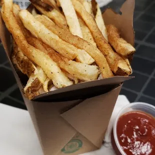a box of french fries with ketchup
