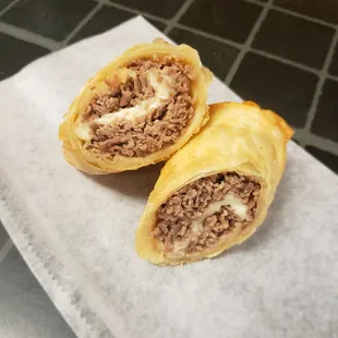 a meat and cheese roll on a napkin