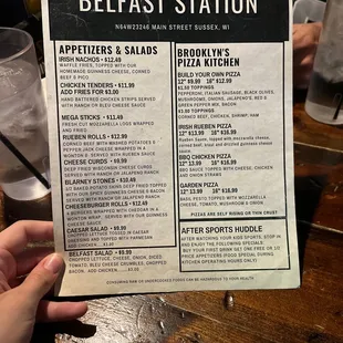 a person holding up a menu