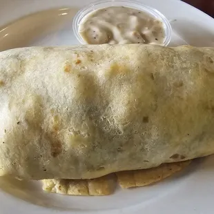 Breakfast burrito with sausage gravy on the side