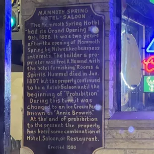 a plaque on the side of the station