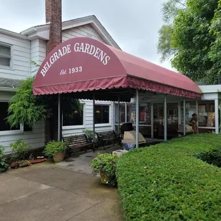 a woman walking in front of a restaurant