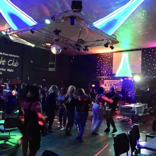 a group of people dancing at a party