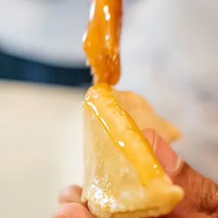 a person holding a piece of food