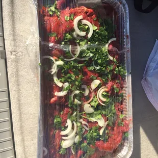 a tray of meat and vegetables