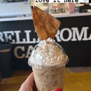 a hand holding a cup of coffee