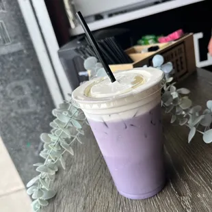 a purple drink with a straw
