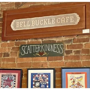 a brick wall with various signs