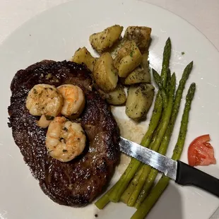 a steak with shrimp and asparagus